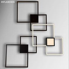 three square and rectangle metal wall art pieces in black, white, and beige