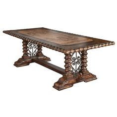 a wooden table with ornate carvings on the top and base, against a white background