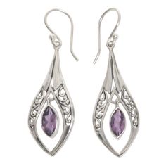 Inspired by the jewelry work of his mother, Wirabhuwana crafts these elegant dangle earrings by hand. Sterling silver with openwork Balinese motifs, and featuring two carats of glittering purple amethyst, these earrings are truly a wonder to behold. Sterling silver, amethyst Hook earrings Combination finish Handmade in & fairly traded from Indonesia Due to the natural materials used in this item, color may vary slightly Paw Print Jewelry, Ribbon Jewelry, Jewelry Workshop, Printed Jewelry, Amethyst Color, Amethyst Earrings, Balinese, Silver Earrings Dangle, Handmade Sterling Silver