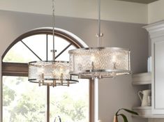 a chandelier hanging from the ceiling in a kitchen