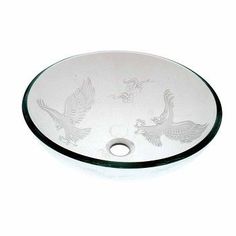 an oval glass sink with two birds on the bottom and one bird in the middle