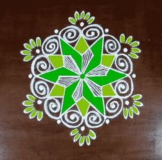 a green and white design on a brown surface