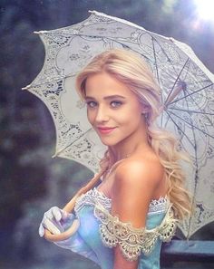 a beautiful woman holding an umbrella in the rain