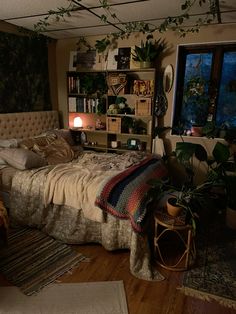 a bed room with a neatly made bed and lots of plants on the shelves next to it