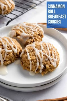 three cinnamon roll breakfast cookies on a white plate with icing drizzled