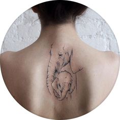 a woman with a tattoo on her back