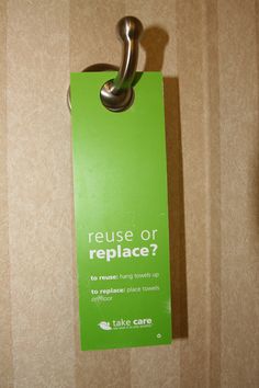 a green sign hanging from the side of a wall that says refuse or replace?