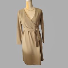 Obtain A Polished Look With This Alfani Wrap Dress. Product Details - On Seam Hidden Side Pockets At Hips - 3/4 Sleeves - Self-Wrap Closure - Lined - Surplice Neckline - A-Line Wrap Silhouette - Color: Fresh Almond (Cream) - Size: Pp (About 2 / 4) See Below Measurements - Arm Length 20" Approx - Armpit To Armpit 16" Approx - Waist 16" Approx - Length 37" Approx Materials & Care - Polyester/ Spandex - Machine Washable Clean, Smoke-Free, Pet-Free Home Bundle Items To Save More Chic Beige Wrap Dress With Surplice Neckline, Spring Long Sleeve Faux Wrap Midi Dress, Long Sleeve Faux Wrap Midi Dress For Spring, Fitted Beige Midi Length Wrap Dress, Fitted Beige Midi Wrap Dress, Fitted Beige Wrap Dress, Beige Long Sleeve Wrap Dress For Spring, Beige Fitted Wrap Dress, Long Sleeve Faux Wrap Dress For Work