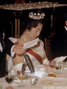 an old photo of a man and woman wearing tiaras