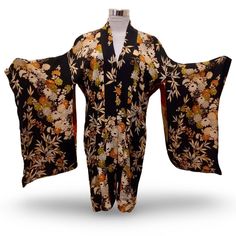 Embrace the beauty of Japanese culture with this stunning black and beig, 1940s,  floral print kimono. The garment boasts 3/4 kimono sleeves and inside ties for closure, making this a perfect casual wear for any occasion. The relaxed fit and rayon material ensure comfort while maintaining a stylish look. This kimono is a one-size-fits-all S, making it a must-have addition to any wardrobe. The topper has been carefully crafted to meet the highest standards, making it ideal for anyone who wants to Vintage Kimono With Kimono Sleeves, Floral Print Kimono For Tea Ceremony, Traditional Black Floral Print Kimono, Traditional Black Kimono With Floral Print, Vintage Black Kimono For Spring, Black Bohemian Kimono With Floral Print, Vintage Long Floral Print Kimono, Bohemian Maternity, Floral Print Kimono