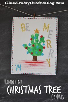 handprinted christmas tree canvas hanging on a clothes line with the words be merry