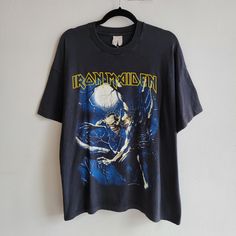 an iron maiden t - shirt hanging on a wall