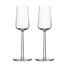 two empty wine glasses sitting next to each other