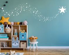 a child's room decorated in blue and white with stars on the wall