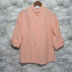 Gretchen Scott Forget Me Knot Top | Blouse Beautiful Striped Orange Color Size Xs Aprox Measurements In Pictures Polyester Cotton Mandarin Collar Button Down 3/4 Sleeves Optional To Cuff Sleeves Handmade Chinese Knot Buttons With Bound Button Holes 7" Bottom Side Slits In Excellent Condition With No Flaws Never Worn Still Available Online Retails $149.00 Perfect Top To Add To Your Collection Please See All Pictures, Video And Measurements As They Are Part Of The Description Casual, Everyday Wear Classic Orange Buttoned Top, Orange Collared Top With Button Closure, Fitted Orange Button-up Blouse, Vintage Orange Button-up Tops, Orange Cotton Button-up Blouse, Career Wear, Fall Wear, Top Knot, Cuff Sleeves