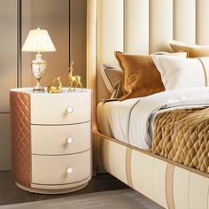 a white bed sitting next to a night stand