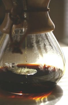 a coffee pot filled with liquid on top of a table