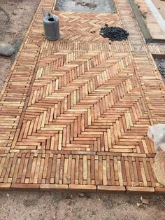 a brick walkway being laid out in the middle of a construction area with tools on it