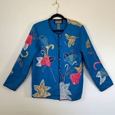 New With Tags Lined Blazer/Jacket, Floral Embroidered Design, Wearable Art, Size Medium (10-12), Bust 37 - 38.5, Waist 28 - 29.5, Hips 38.5 - 40, 5 Lucite Button Front Closure, Extra Button Sewn Inside Seam, Taped Shoulder Seams To Control Stretch, Color: Blue Pink Yellow White Purple Cream Black Embroidery, Shell 52% Cotton 48% Rayon, Lining 100% Polyester, Made In India, Subtle Interior Sewn In Shoulder Pads, In Excellent Condition Festive Long Sleeve Outerwear For Spring, Blue Embroidered Cotton Outerwear, Blue Cotton Outerwear With Floral Embroidery, Festive Blue Long Sleeve Outerwear, Festive Blue Outerwear With Floral Embroidery, Festive Blue Floral Embroidery Outerwear, Blue Long Sleeve Outerwear With Floral Embroidery, Blue Embroidered Outerwear For Spring, Festive Long Sleeve Casual Outerwear