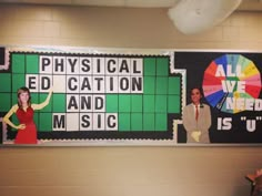 two people are standing in front of a large poster that says physical education and music