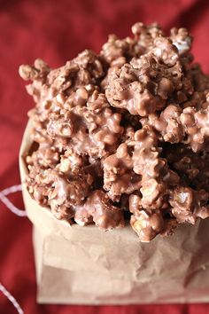 a bowl full of chocolate popcorn on top of a table