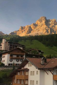 the mountains are in the background with houses on each side and balconies at the bottom