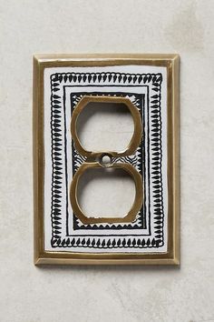 a decorative light switch plate with an ornate design