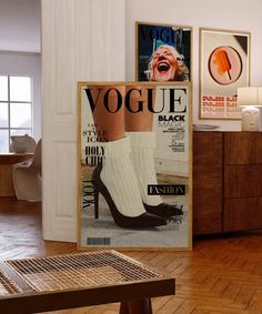 a magazine cover sitting on top of a hard wood floor next to a wooden table