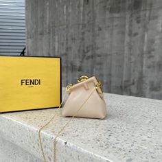 FND Nano First Charm Beige Bag For Woman 10cm/4in Rep 1:1 Size: 10 x 5.5 x 11.5 cm / 4 x 2 x 4.5 inch FND First Nano bag, with diagonal FF clasp and clip at the back that allows it to be attached to larger bags or belts like a charm. It can also ... Louis Vuitton Shirt, Fendi Peekaboo, Beige Bag, Bottega Veneta Shoulder Bag, Handbag Wallet, Evening Clutch Bag, Wallet Accessories, Wireless Earbuds, Airpods Pro