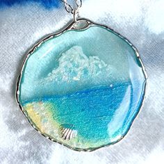 a glass pendant with an ocean scene on it