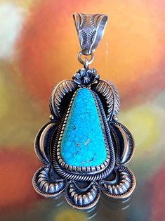 This Kirk Smith vintage sterling silver pendant showcases a beautiful large Birdseye Turquoise. The style and design is clearly "Kirk", and the turquoise selection is perfect.  Measurements: -Dimensions- 3-1/4"H x 1-3/8"W -Weight- 1.1 oz, or 31g About the Artist: Kirk Smith was a Navajo silversmith who learned his craft in the 1960's from his Grandfather. In 1972 he went out on his own, and later started working with his brother~in~law Harry Morgan in the 80's when his career really blossomed.  Unfortunately Kirk passed away in September of 2012. At the time he was already a very well established silversmith with a unique style of his own. His pieces are now sought after by collectors worldwide, and are difficult to find. Note: As this is pre-loved and not quite brand new, it has some mino Collectible Teardrop Turquoise Jewelry, Antique Untreated Turquoise Jewelry, Collectible Blue Turquoise Necklace With Large Pendant, Blue Turquoise Necklace With Large Pendant, Collectible Engraved Turquoise Necklace, Vintage Sterling Silver Turquoise Necklace With Patina, Untreated Turquoise Pendant Necklace Collectible, Untreated Turquoise Pendant Necklace For Collectors, Collectible Turquoise Sterling Silver Necklace