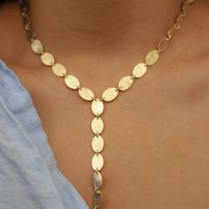 -18k gold plated long necklace with small ovals cascading down in the center -Measures 18" -Handmade in Brazil -Please note that our brand uses natural semi-precious stones--each piece has a unique texture, shine, and color Adjustable Dainty Oval Necklace, Adjustable Oval Dainty Necklace, Dainty Oval Adjustable Necklace, Oval Brass Necklace With Adjustable Chain, Handmade Long Drop Lariat Necklace, Elegant Handmade Lariat Drop Necklace, Oval Gold Necklace In 14k Gold Filled, Gold Oval Bohemian Necklace, Handmade Gold Lariat Long Necklace