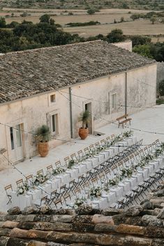 an aerial view of a building with tables and chairs set up outside