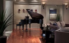 a living room filled with furniture and a grand piano