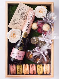 an open box filled with different types of food and drink on top of a table