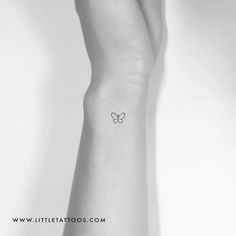 a small butterfly tattoo on the left inner arm and wrist, by little tatoos