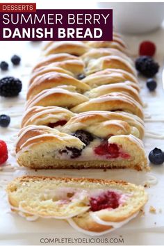 a long loaf of fruit bread with berries on the side