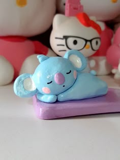 hello kitty figurines sitting on top of a purple object