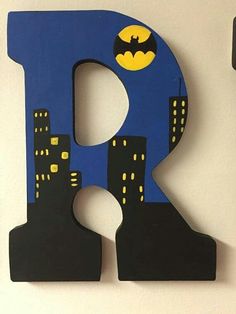 a wooden letter shaped like the letter e with batman on it