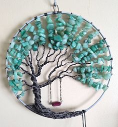 a wire tree with green beads hanging from it