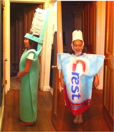 two children dressed in costumes standing next to each other with toothbrushes on their heads