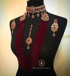 a mannequin with red and gold jewelry on it