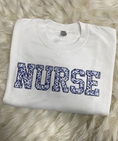 Nurse Embroidered Blue Floral Applique Sweatshirt Simple Doctor Pullover, Gift for Medical Field, Personalized RN Shirt - Etsy Blue Long Sleeve T-shirt With Embroidered Text, Blue Embroidered T-shirt For Fall, Blue Tops With Letter Embroidery For Winter, Blue Winter Tops With Letter Embroidery, Winter Blue Tops With Letter Embroidery, Blue Cotton Sweatshirt With Embroidered Graphics, Embroidered Cotton Blue Sweatshirt, Blue Long Sleeve T-shirt With Embroidered Logo, Blue Tops With Letter Embroidery For Spring