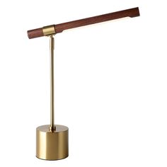 a brass and wood desk lamp on a white background