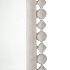 a tall white column with several balls on it