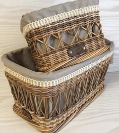 two wicker baskets stacked on top of each other, one is grey and the other is brown