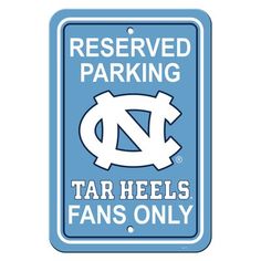 a blue sign that says reserved parking tar heels fans only