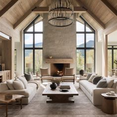 a living room filled with furniture and a fire place in the middle of a room