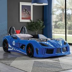 a blue sports car bed in a bedroom