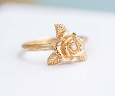 "ღ Immediately fell in love with!. This Rose Flower ring, This ring carved shaped as a rose flower and was also decorated with Natural Diamond and were elaborately installed on the ring by skilled craftsmen, On the surface wood carving pattern. Which makes this ring definitely unique. ♦ Description Product ♦ ✦ MAIN STONE DETAIL ✦  ➤  Main Stone : Natural Diamond ➤ Size: 1.3 mm ➤ Weight : 0.01 carats ➤  Clarity : VVS ➤ Shape : Round ➤  Color : D color  ➤ Cut Grade : Belgium Cut ✦ FLOWER SIZE  ✦ BAND DETAIL ✦ ➤  Flower Size : 7.0 mm ➤ Band Width：1.8 mm ➤ Band Thickness : 1.5 mm ✦ MATERIAL ✦ WEIGHT ✦ ➤ Material Gold : 10K Gold , 14K Gold , 18K Gold ➤ Rose Gold - Yellow Gold - White Gold ( Plated Rhodium ) /  Platinum 950 ➤ Weight of Gold : 10K Gold ➢ 2.0 - 2.5 Gram , 14K Gold ➢ 2.6 - 3.0 Gram Elegant Floral Rings With Rose Details, Luxury Flower Shaped Ring For Wedding, Luxury Flower Wedding Ring, Rose-colored Fine Jewelry Flower Ring For Anniversary, Exquisite Flower-shaped Ring For Anniversary, Exquisite Flower Ring For Anniversary, Rose Flower Ring For Anniversary, Fine Jewelry, Luxury Rose Gold Flower Ring For Wedding, Rose Flower Ring For Wedding